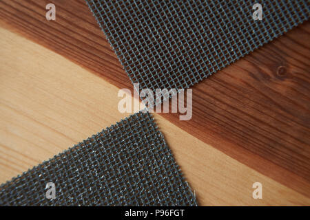 Sanding sheets on a wooden surface. Close-up abrasive equipment with copy space Stock Photo
