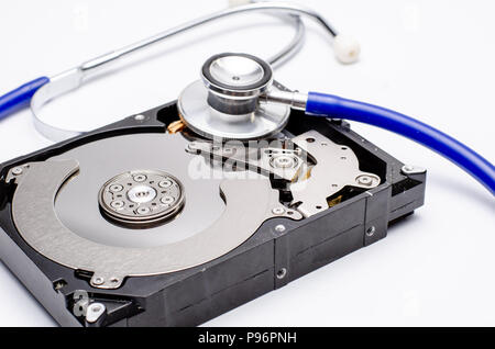 Close up computer hard disk and stethoscope data health check, data security concept on white background Stock Photo