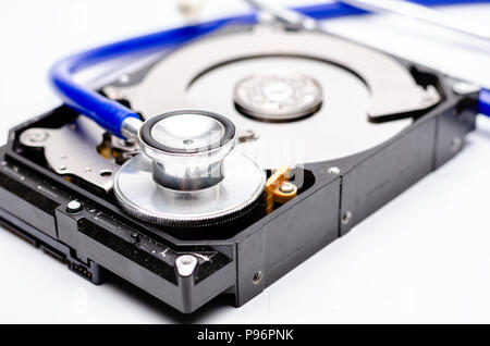 Close up computer hard disk and stethoscope data health check, data security concept on white background Stock Photo