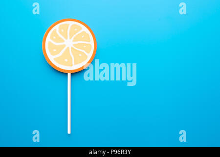 Candy stick, isolated on blue background  Stock Photo