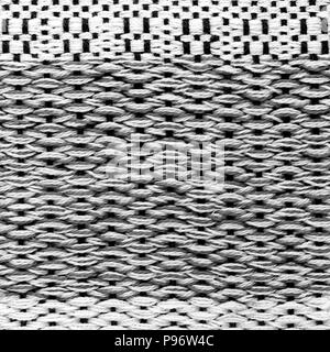 Black hand weaving matting tweed fabric texture. Closeup square fragment Stock Photo