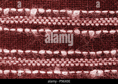 Red hand weaving matting tweed fabric texture. Closeup horizontal fragment Stock Photo
