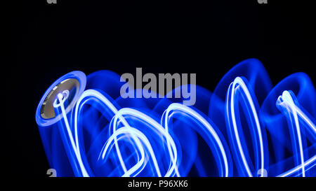 Light painting by computer on-off switch. Abstract artistic drawing. Black background. Beautiful motion blur. Blue glowing push-button with LED diode. Stock Photo