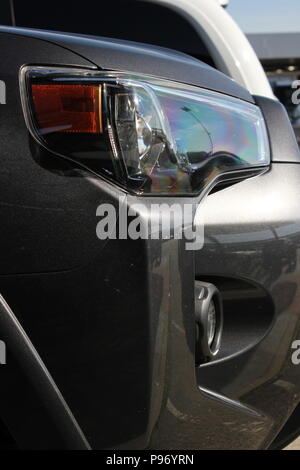 Modern SUV car with headlight optics at the car wash. Car care and