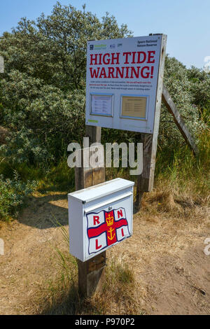 RNLI and High Tide warning sign, Spurn Head, Spurn Point, sand spit, near Hull East Yorkshire, UK Stock Photo
