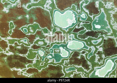 Texture of rusty colorful metal background with a peeling cracked layers of paint. Stock Photo
