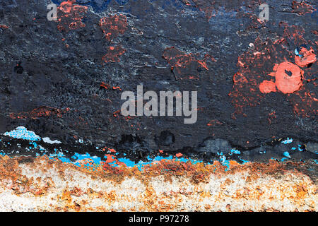 Texture of rusty colorful metal background with a peeling cracked layers of paint. Stock Photo