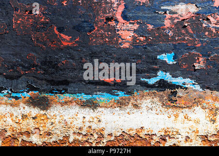 Texture of rusty colorful metal background with a peeling cracked layers of paint. Stock Photo