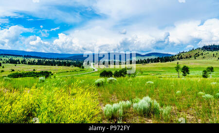 Highway 5A winding through the wide open Grass Lands of the Nicola Valley, between Merritt and Kamloops, British Columbia, Canada, under cloudy skies Stock Photo