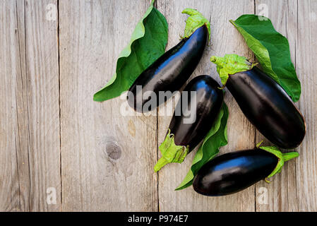 Ripe eggplants on a wooden background. Top view, flat lay. Stock Photo