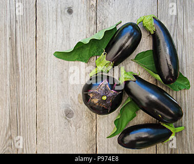 Ripe eggplants on a wooden background. Top view, flat lay. Stock Photo