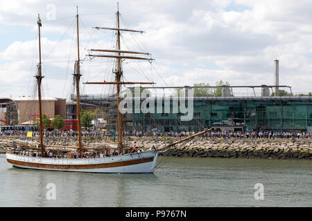 Sunderland, UK. 14th July 2018. The Vega Gamleby sails past the UK's National Glass Centre in Sunderland, England. The ship iis participating in the Parade of Sail at the start of the 2018 Tall Ships Race. Credit: Stuart Forster/Alamy Live News Stock Photo