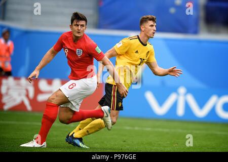 July 14th, 2018, St Petersburg, Russia. Harry Maguire of England and ThomasMeunier (15)of Belgium in action during the 2018 FIFA World Cup Russia match between England and Belgium at Saint-Petersburg Stadium, Russia. Shoja Lak/Alamy Live News Stock Photo