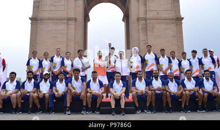 New Delhi, India. 15th July, 2018. Indian athletes and officials pose with the Asian Games torch near the India Gate monument in New Delhi, India, July 15, 2018. The 18th Asian Games is scheduled to begin in Jakarta on August 18. Credit: Partha Sarkar/Xinhua/Alamy Live News Stock Photo