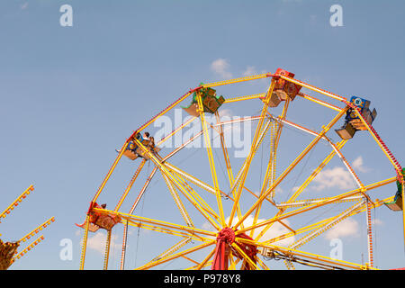 Bedford, England. 15 July 2018: Big wheel fun fair ride with blue sky on sunny summer day at the 40th River Festival in Bedford, Bedfordshire, England. Martin Parker/Alamy Live News Stock Photo