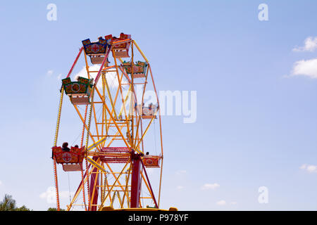 Bedford, England. 15 July 2018: Big wheel fun fair ride with blue sky on sunny summer day at the 40th River Festival in Bedford, Bedfordshire, England. Martin Parker/Alamy Live News Stock Photo