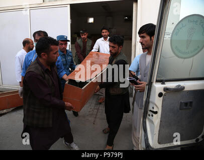 Kabul, Afghanistan. 15th July, 2018. People carry the coffin of a victim of a suicide attack at a local hospital in Kabul, capital of Afghanistan, July 15, 2018. At least eight people, including an assailant, were killed and 17 others wounded after a suicide bomb blast rocked near a government ministry office in western neighborhood of Kabul Sunday, authorities said. Credit: Rahmat Alizadah/Xinhua/Alamy Live News Stock Photo