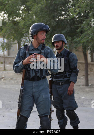 Kabul, Afghanistan. 15th July, 2018. Afghan security force members stand guard at the site of a suicide attack in Kabul, capital of Afghanistan, July 15, 2018. At least eight people, including an assailant, were killed and 17 others wounded after a suicide bomb exploded near a government ministry office in western Kabul on Sunday, authorities said. Credit: Rahmat Alizadah/Xinhua/Alamy Live News Stock Photo