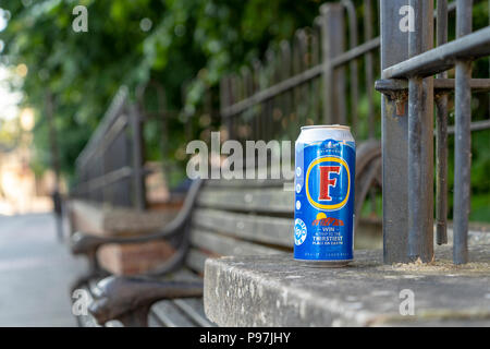 Fosters beer can left on wall Stock Photo