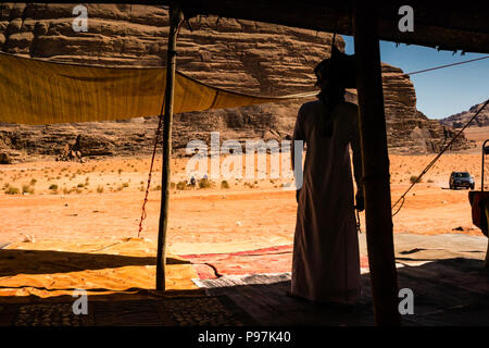 Arab Bedouin man awaits customers, Bedouin camp, Wadi Rum desert valley, Jordan, Middle East Stock Photo
