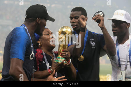 France's Paul Pogba (centre right) celebrates with the trophy after winning the FIFA World Cup Final at the Luzhniki Stadium, Moscow. Stock Photo