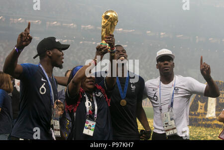 France's Paul Pogba (centre right) celebrates with the trophy after winning the FIFA World Cup Final at the Luzhniki Stadium, Moscow. Stock Photo