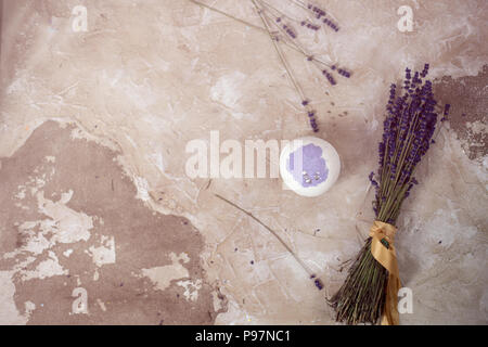Natural cosmetics. Handmade lavender bath bombs, lavender flowers and towel on white wooden planks, top view Stock Photo