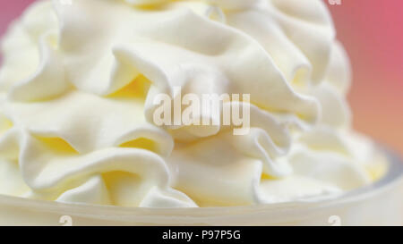 Swirls of whipped cream, macro closeup preparation for cake decorating. Stock Photo