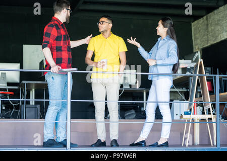 Team of Creative Young People Chatting in Office Stock Photo