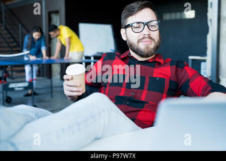 Modern Bearded Man Chilling in Office Stock Photo