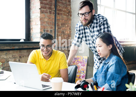 Creative Business Team Using Computer in Office Stock Photo