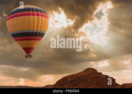 Hot Air Balloon travel over desert Stock Photo