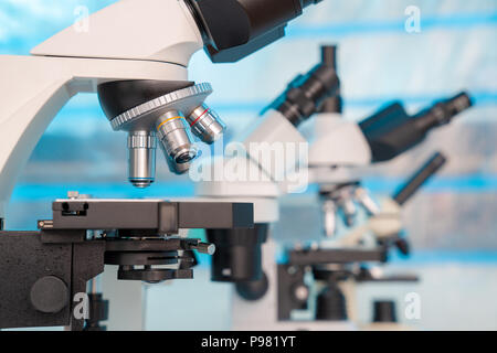 Four microscopes of different designs in the laboratory Stock Photo