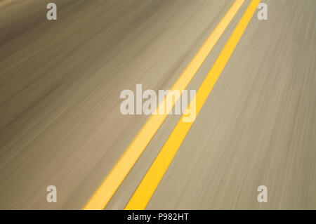 motion blurred double yellow lines on road Stock Photo