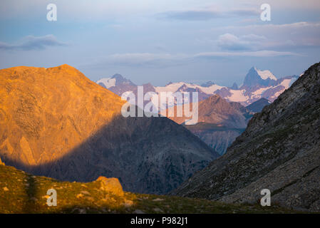 Massif des Ecrins (4101 m), France. Colorful sky at sunrise, majestic peaks and glaciers, dramatic landscape. Stock Photo