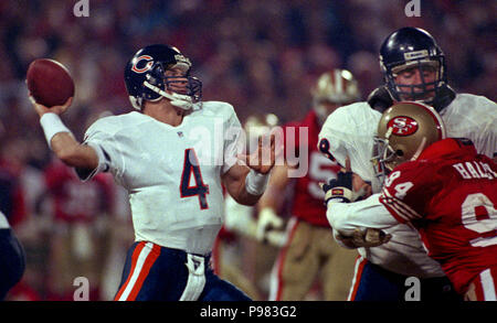 San Francisco, California, USA. 23rd Dec, 1991. San Francisco 49ers vs. Chicago  Bears at Candlestick Park Monday, December 23, 1991. 49ers beat Bears  52-14. Bears quarterback Jim Harbaugh (4) passes ball under pressure from  49er defensive end