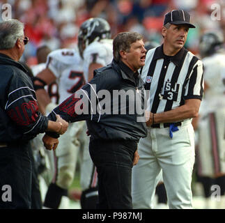 Former Atlanta Falcons Head Coach Jerry Glanville, left, stands with former Atlanta  Falcons quarterback Michael Vick on the turf before the first half of an  NFL football game between the Atlanta Falcons