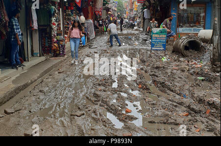 Kathmandu, Nepal. 15th July, 2018. People walk across a muddy road after rainfall in Kathmandu, Nepal, on July 15, 2018. Credit: Sunil Sharma/Xinhua/Alamy Live News Stock Photo