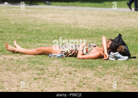 London UK. 16th July 2018 .  A woman sunbathing in Potters Fields  on another hot day as the ongoing heatwave which has lasted more than 30 days is set to continue and Britain's hottest summer since 1976 Credit: amer ghazzal/Alamy Live News Stock Photo