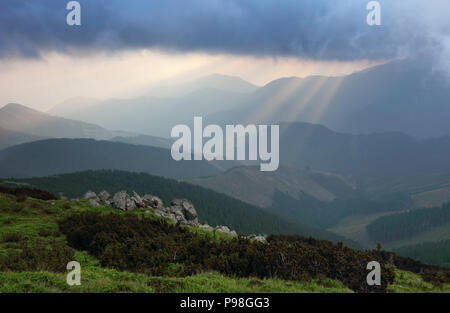 sun rays bursting through the skies in late afternoon Stock Photo