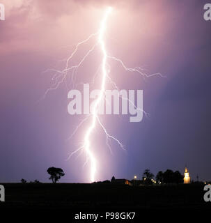 Lightning bolt at strom over village Stock Photo