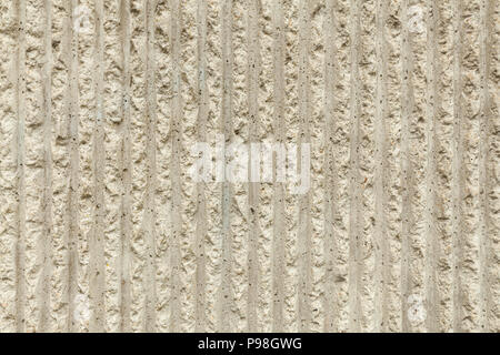 Surface of the wall with a decorative white plaster. Textured concrete wall with vertical lines and stripes as a texture or background. Repair, design Stock Photo