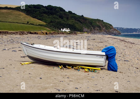 Small fishing boats hauled up on the beach at Beesands, a small former fishing village in south Devon. Stock Photo