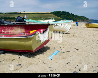 Small fishing boats hauled up on the beach at Beesands, a small former fishing village in south Devon. Stock Photo