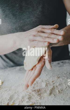 Process of cutting dough making dish cooking homemade dough. Chef makes fresh dough Stock Photo