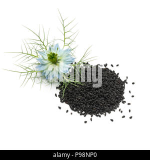 Heap of black nigella seeds and blue flower isolated on white background Stock Photo