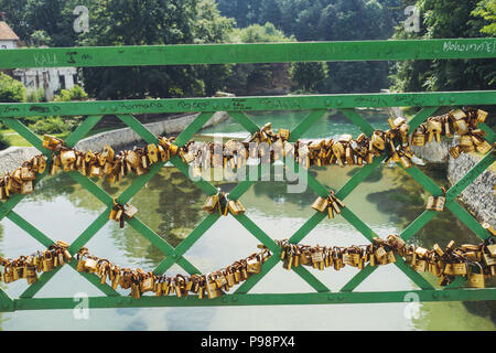 Countless small padlocks attached to a railing on a footbridge over the Pliva River, in the town of Jajce, Bosnia and Herzegovina Stock Photo