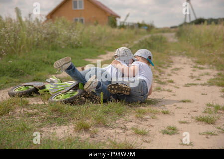 two brothers playiung outside and having a tumble Stock Photo