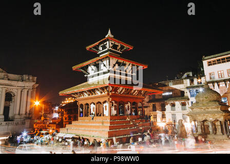 Kathmandu, Bagmati, Nepal : Trailokya Mohan Narayan Temple and incidental people at night at the Unesco listed Durbar Square. Stock Photo