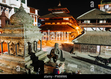 Kathmandu, Bagmati, Nepal : People next to the Garuda statue at the Unesco listed Durbar Square at night. Stock Photo